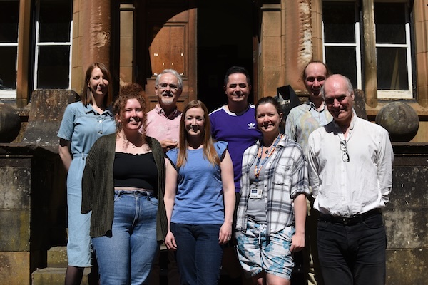 Photo of EDI Committee on old building steps: Mara Dougall, Ian MacLaren, Karl Toland, David Boldrin, Lauren Muir, Fiona Speirits, Claire Neilan, Norman Gray
