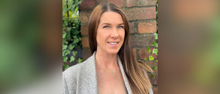 Dr Lindsay Balfour posing for a professional headshot, looking at camera