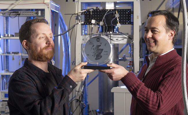 Dr Paul Reynolds and Prof Martin Weides admiring the commemorative 850-year anniversary of Glasgow wafer