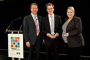 Stuart Dalgleish, centre, receiving his award from Michael Portillo, left, and Sara Reading, Head of Graduate Recruitment at KPMG.