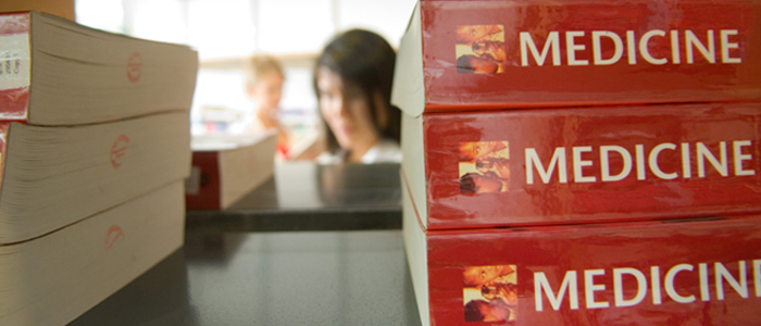 Image of medicine textbooks on library shelf