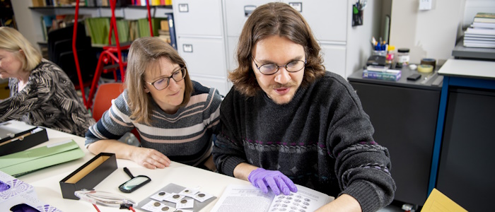 Two classics researchers working with samples