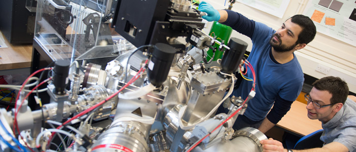 PLD vacuum chamber. Scientists setting up an experiment