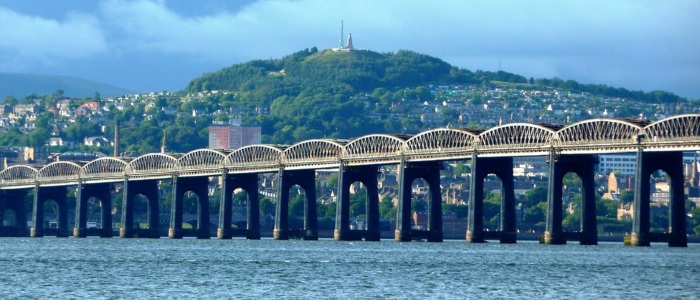 A view of Dundee railway bridge with the city of Dundee and Law Hill in the background