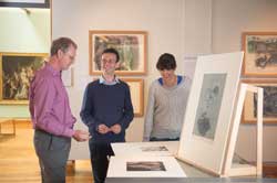 Hunterian curator Peter Black with colleagues looking at German Expressionist prints in the Hunterian Art Gallery.
