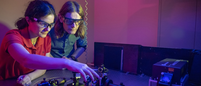 Physics students using quantum equipment