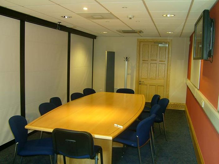 Flat floored meeting room with boardroom table and chairs