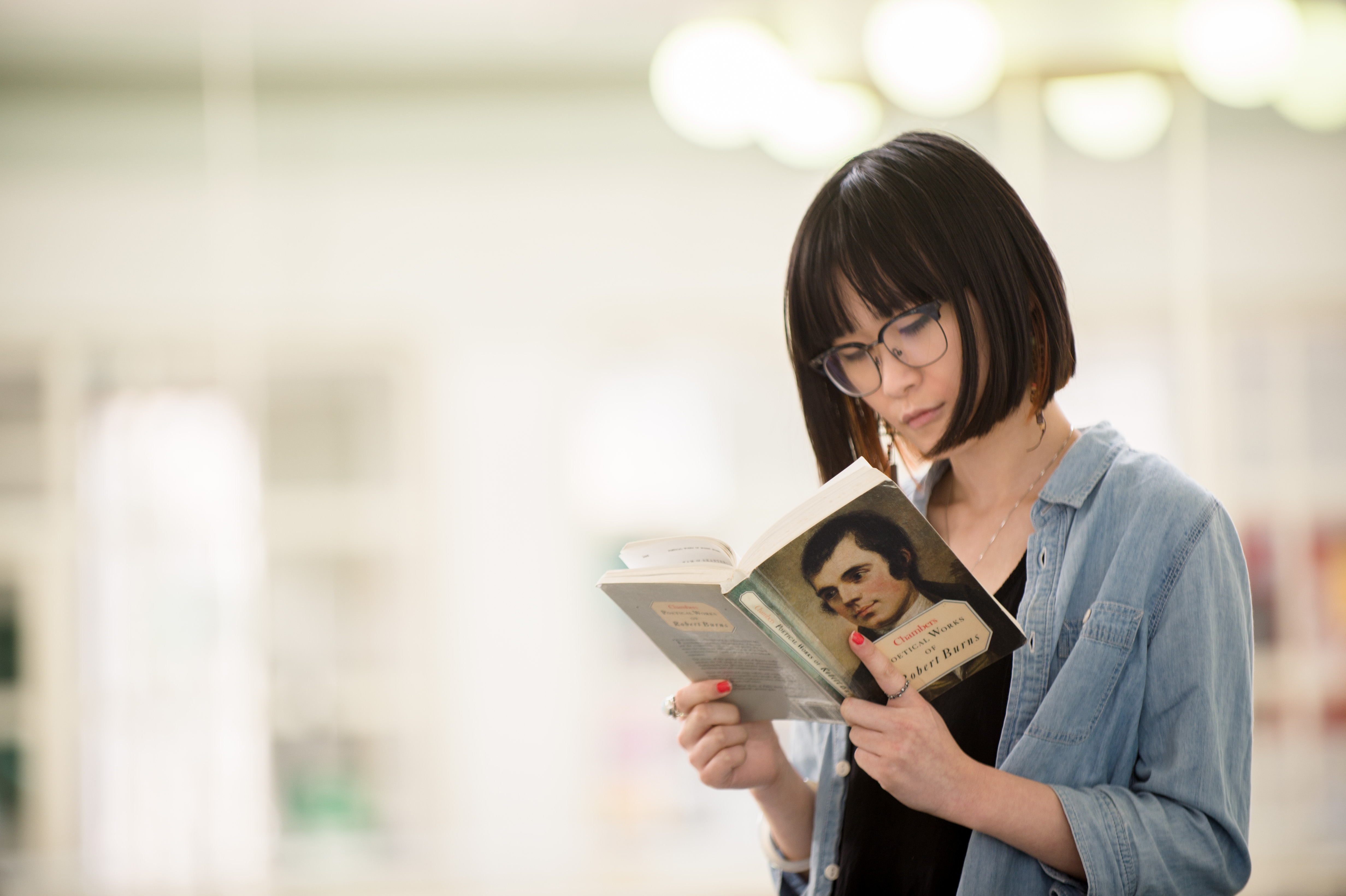Student reading a Robert Burns book