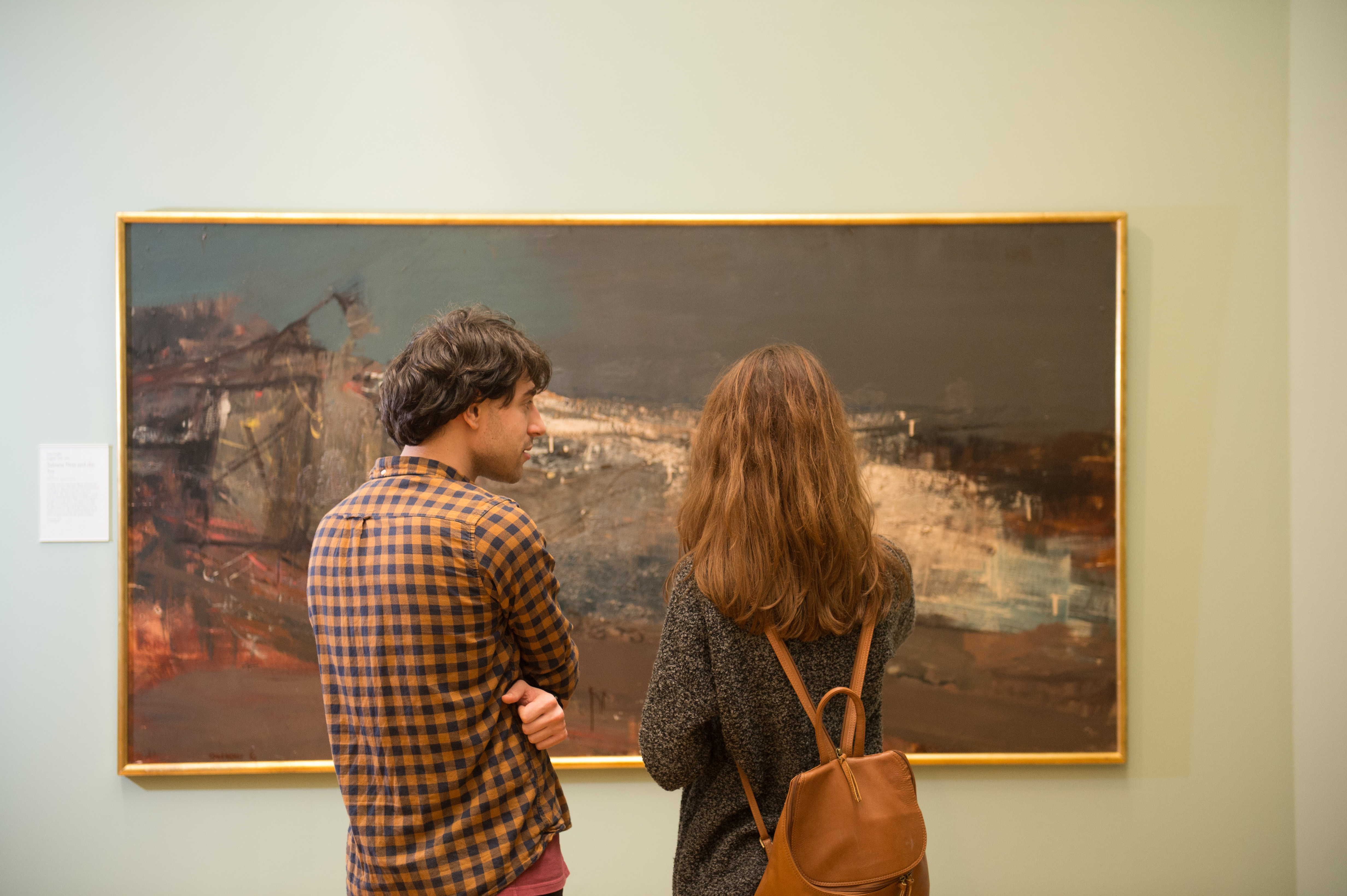 Two students looking at a painting in the Hunterian Art Gallery