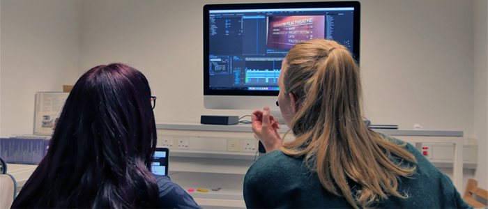 students editing at a computer