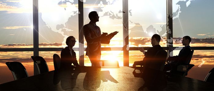 Image of four business people in a boardroom 