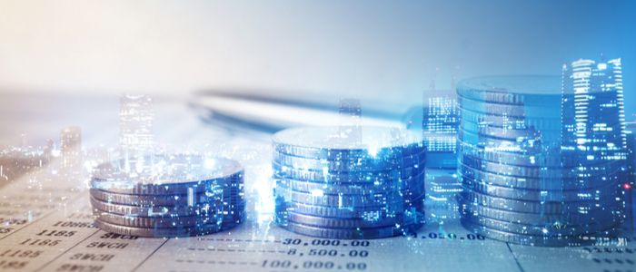 Image of three stacked coins with buildings in the background