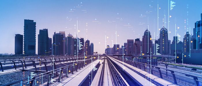Image of modern train tracks in front of skyscrapers 
