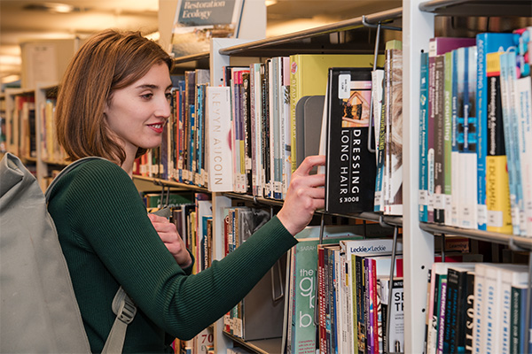 A student in the library at Dumfries campus