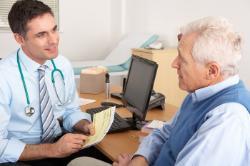 Photo of older man consulting with GP