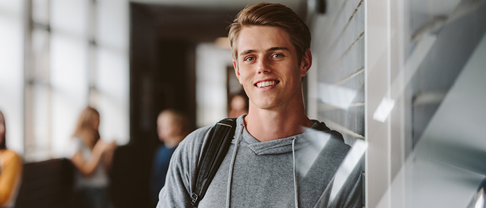 Image of male student with students in background