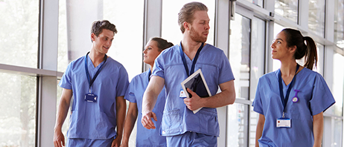 Image of health care professionals wearing blue scrubs