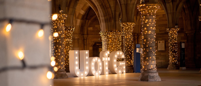 UofG letters lit up in undercroft during graduation