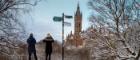 Students looking at the tower next to a sign post