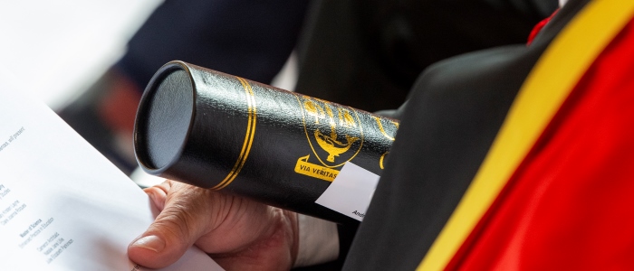 Graduation scroll in hand