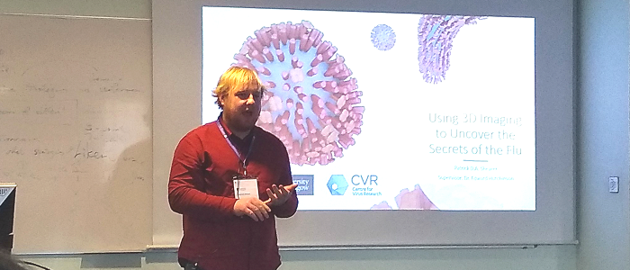 PhD student Patrick Shearer presenting in front of one of his slides