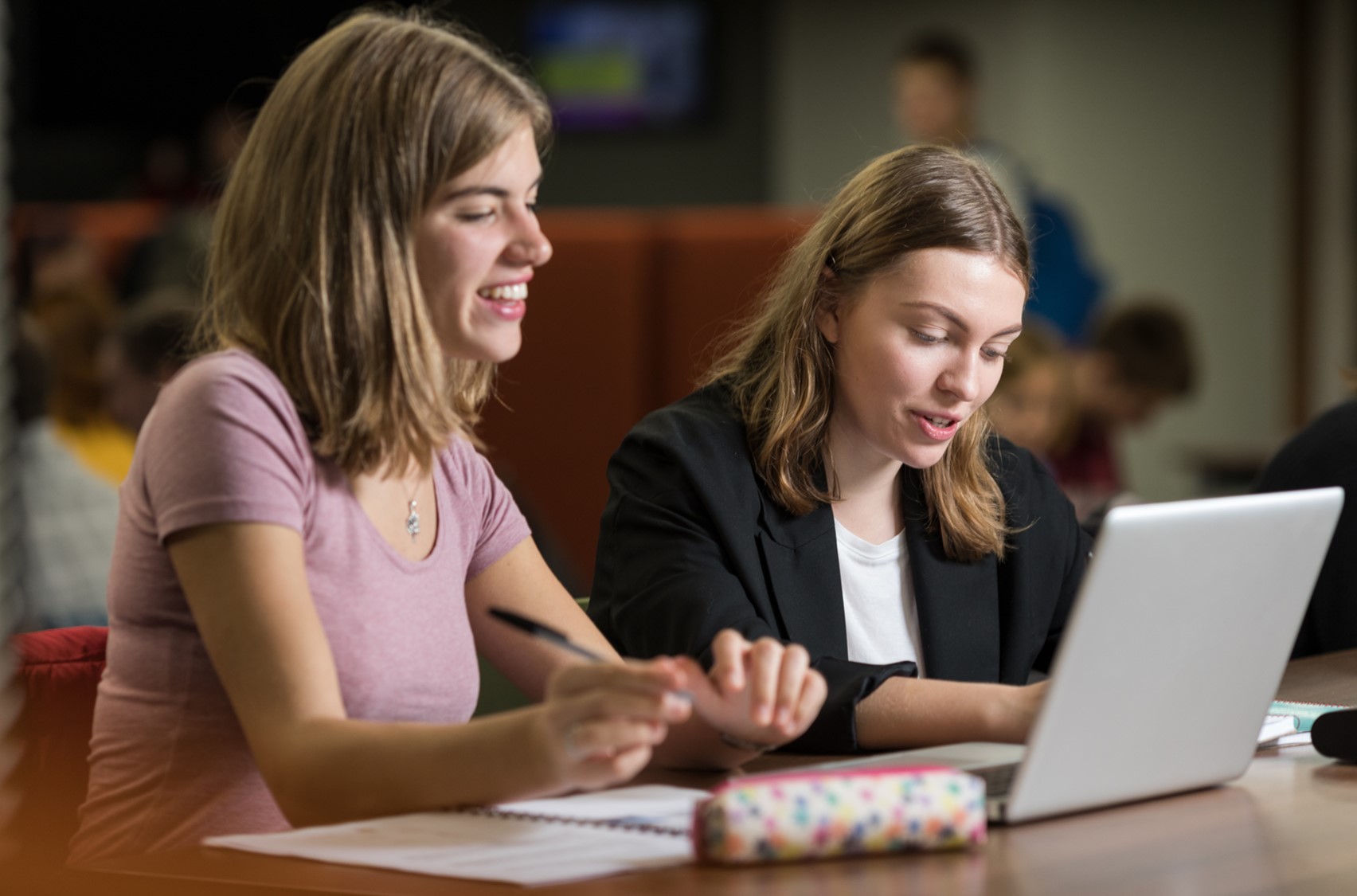 Two students working on laptops