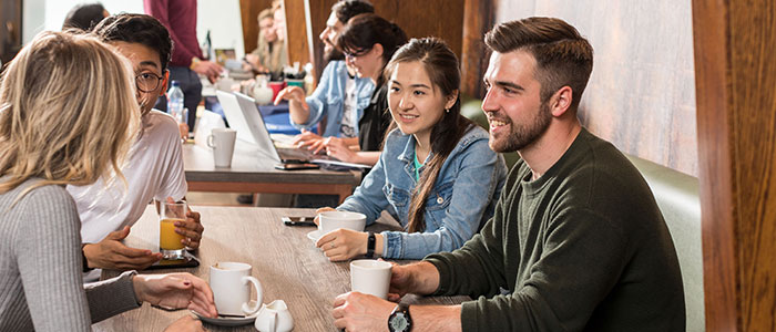 Students having coffee in the Gilchrist postgraduate club