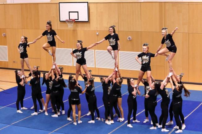 Cheer level two performing a pyramid stunt, pre-lockdown Cheer level 2 doing a pyramid stunt