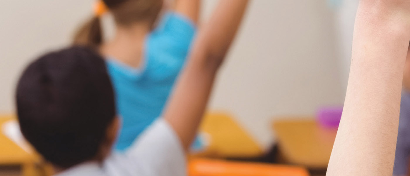 Schoolchildren with hands up