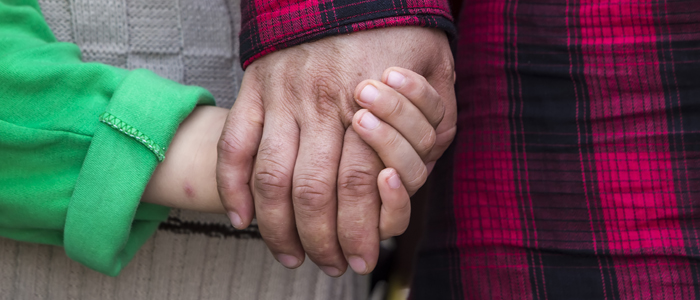 Asylum seekers holding hands