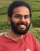 A head and shoulders shot of Kannan Venugopal with a field in the background