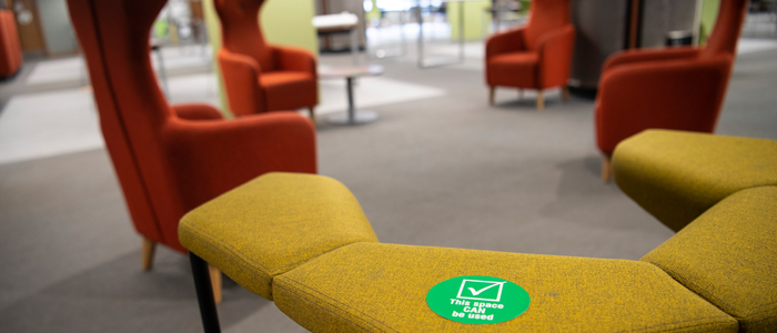 Empty study spaces in the library with green sticker