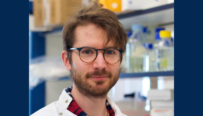 A head and shoulders shot of Dr Adam Fletcher in the lab
