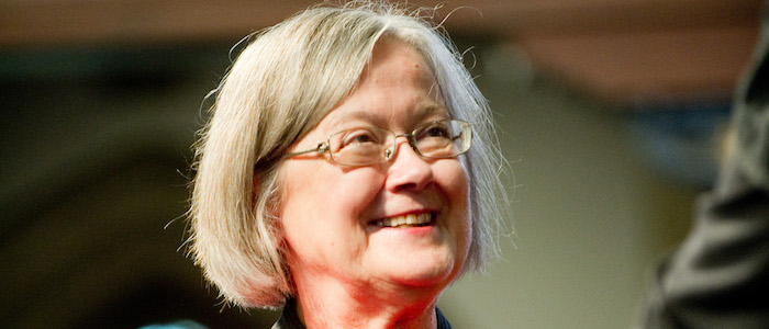 An older woman smiling away from camera