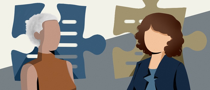 Image of 2 people with a jigsaw puzzle shape behind them 