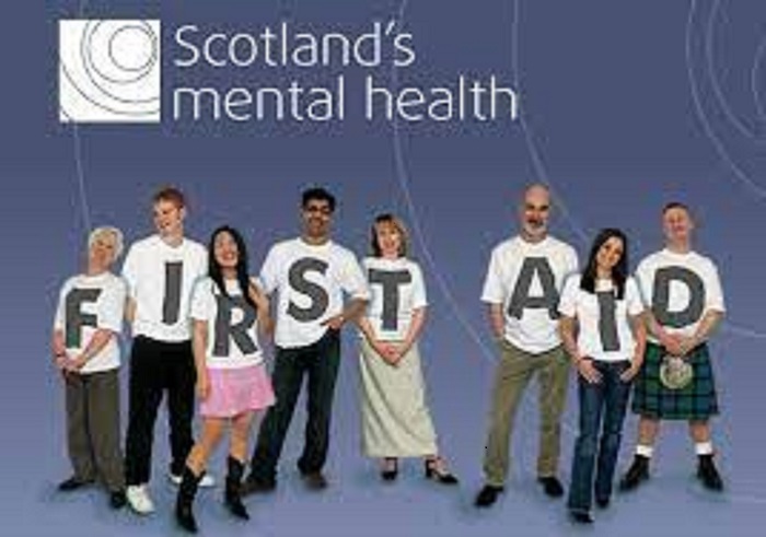 group of people wearing t-shirts which spell out First Aid with headline Scotland's Mental Health