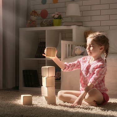 Little girl playing with building bricks