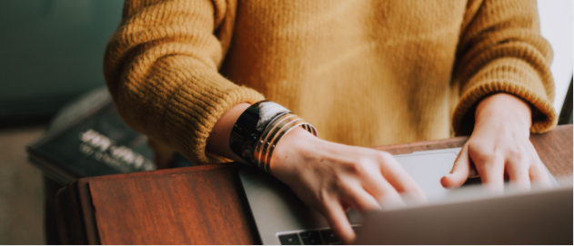 Image of someone typing on a laptop