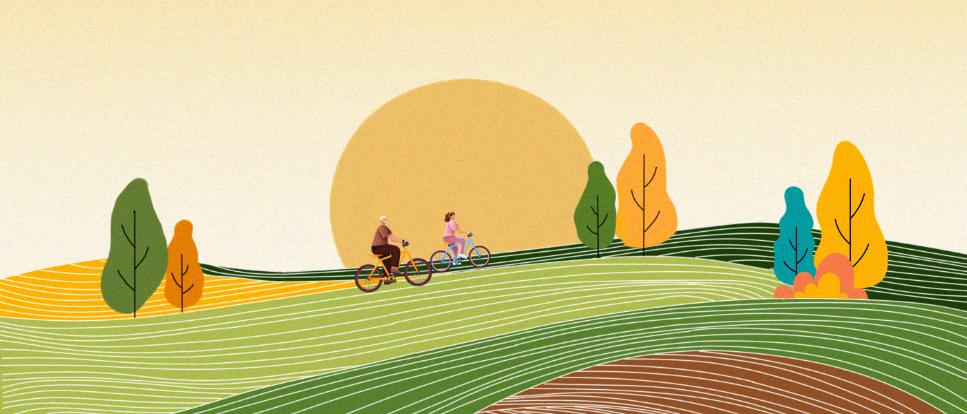Two people on bicycles with sun rising