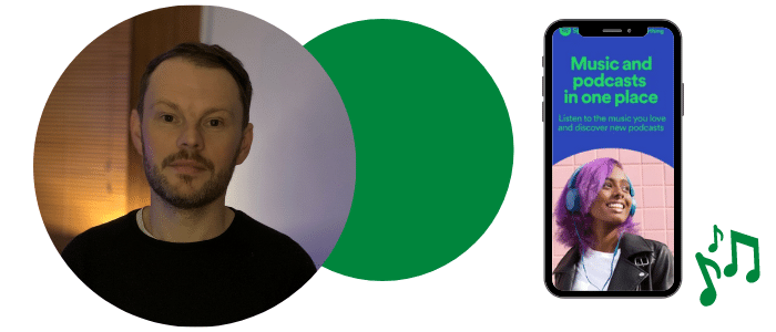 A person, with a phone which displays the Spotify app