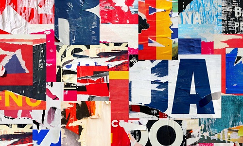 Close up of layered posters, some torn, multicoloured