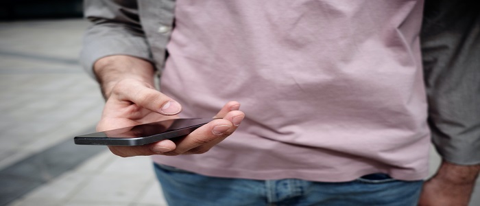 Someone holding a smart phone (torso only)