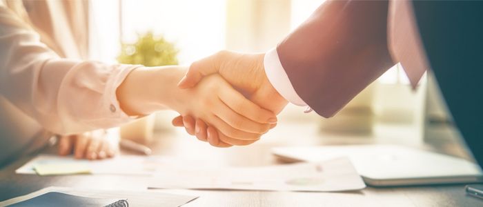 Image of a man and woman shaking hands