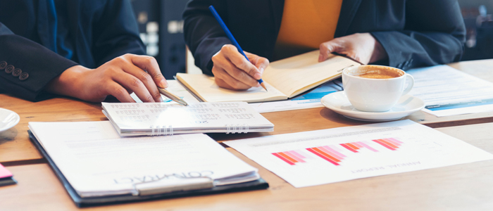 Photo of two people working together on charts 