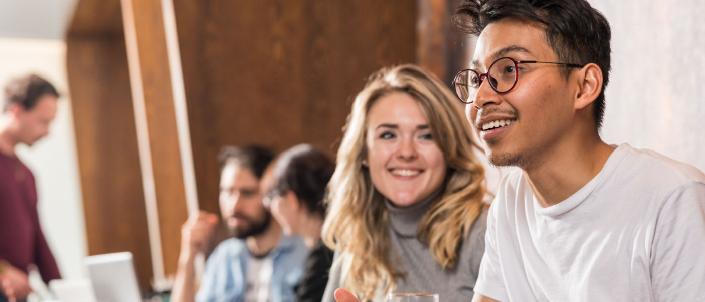 Photo of postgraduate researchers in the Gilchrist cafe talking