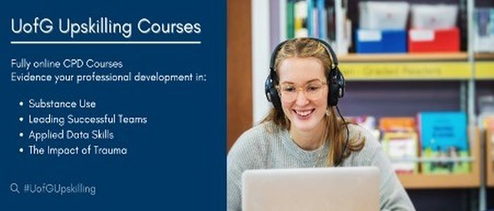 Student sitting in front of a laptop with headphones on 