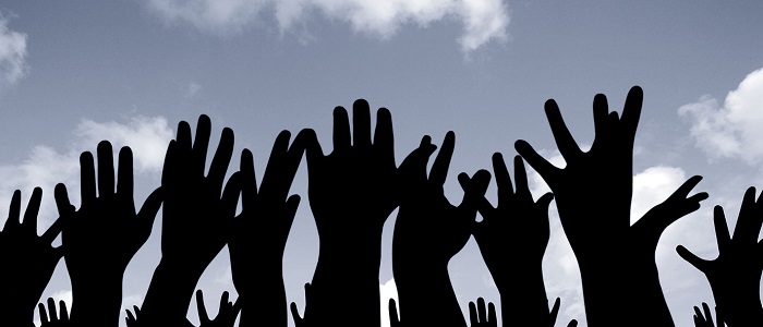 Human hands in the air shadows against the sky