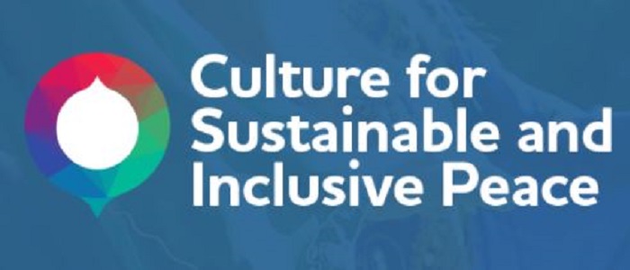 White text on blue background with round rainbow logo with a white centre