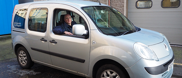 Image of Jim Blunn in small van used for transporting staff and equipment.