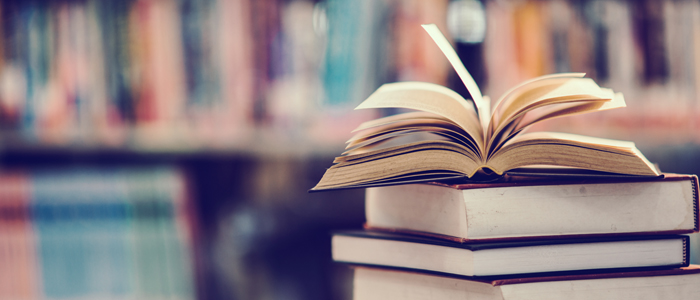 Photo of books on a table in a library